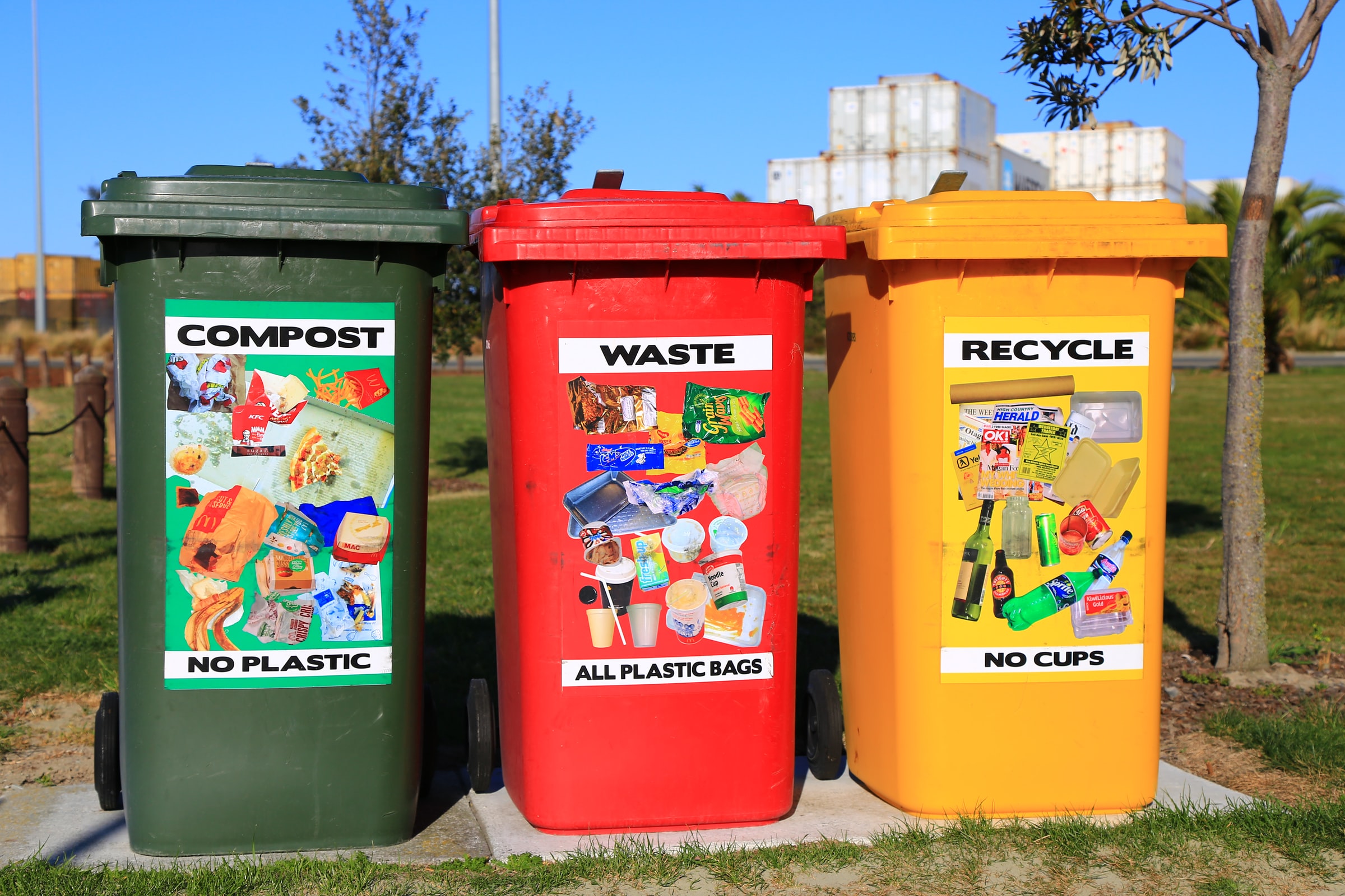 3 bins, lined up next to each other - compost, waste, and recycle